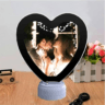 Heart-shaped magic mirror that reveals a personalized photo when illuminated, featuring an elegant design perfect for home decor and gifting.